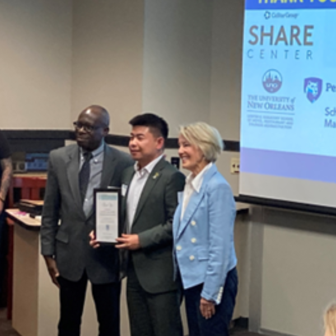 Godwin-Charles Ogbeide presenting Dr. Fang Shu a thank you plaque for Dr. Michael Cheng, FIU Dean, with Fran Brasseux, ICHRIE CEO.